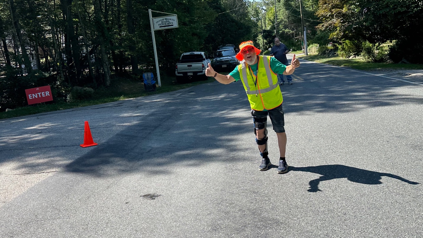 A person wearing a safety vest and orange hat
AI-generated content may be incorrect.