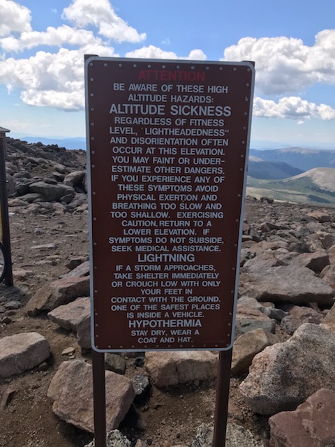 A sign on the side of a mountain

Description automatically generated