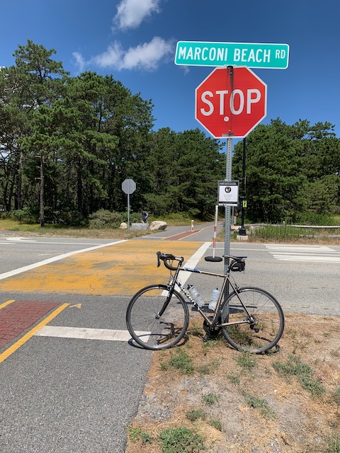 A stop sign on street next to a bicycle

Description automatically generated